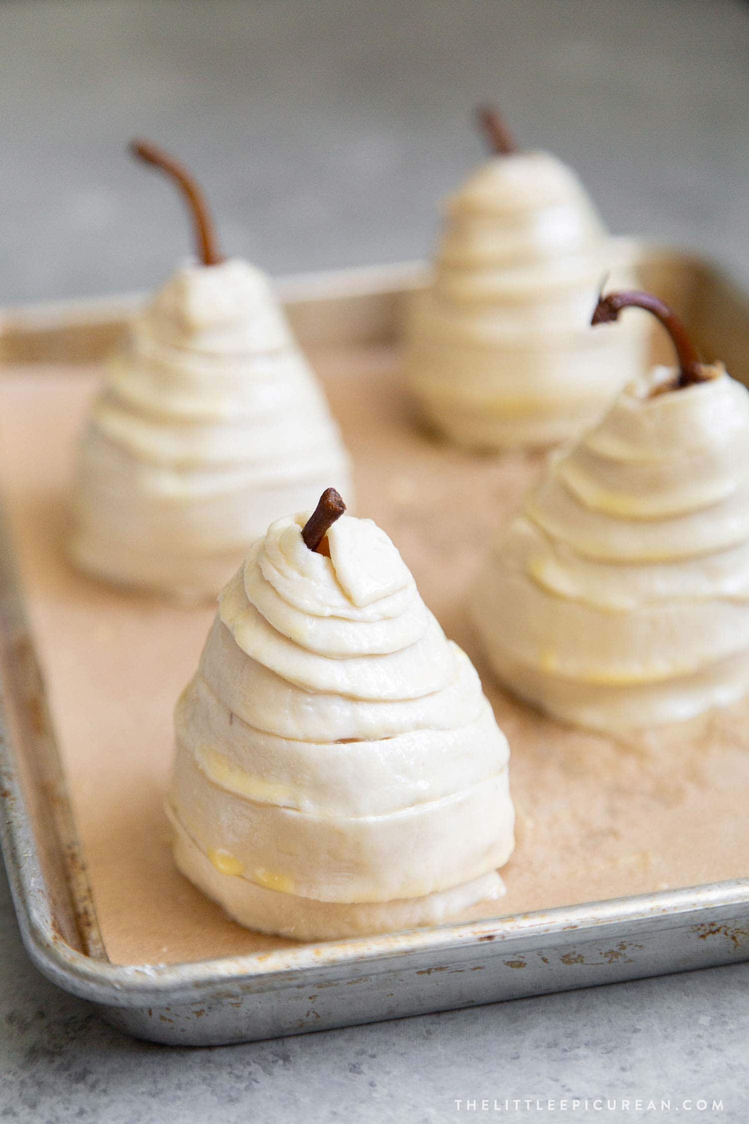 Chilled poached pears encased in puff pastry strips. Then, baked until golden brown. 