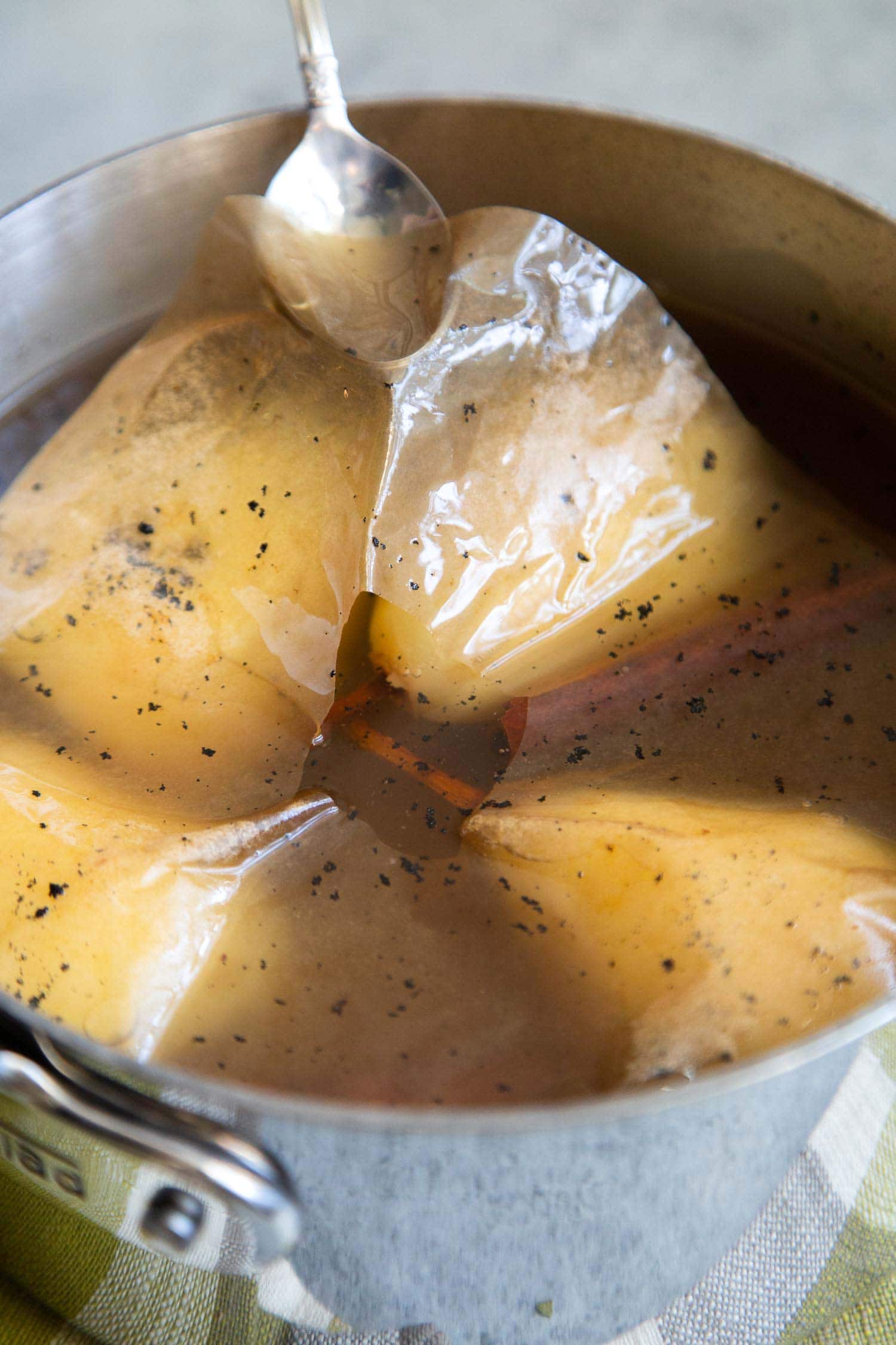 Use a cartouche to cover poached pears during simmering. Blog post explains this easy trick!