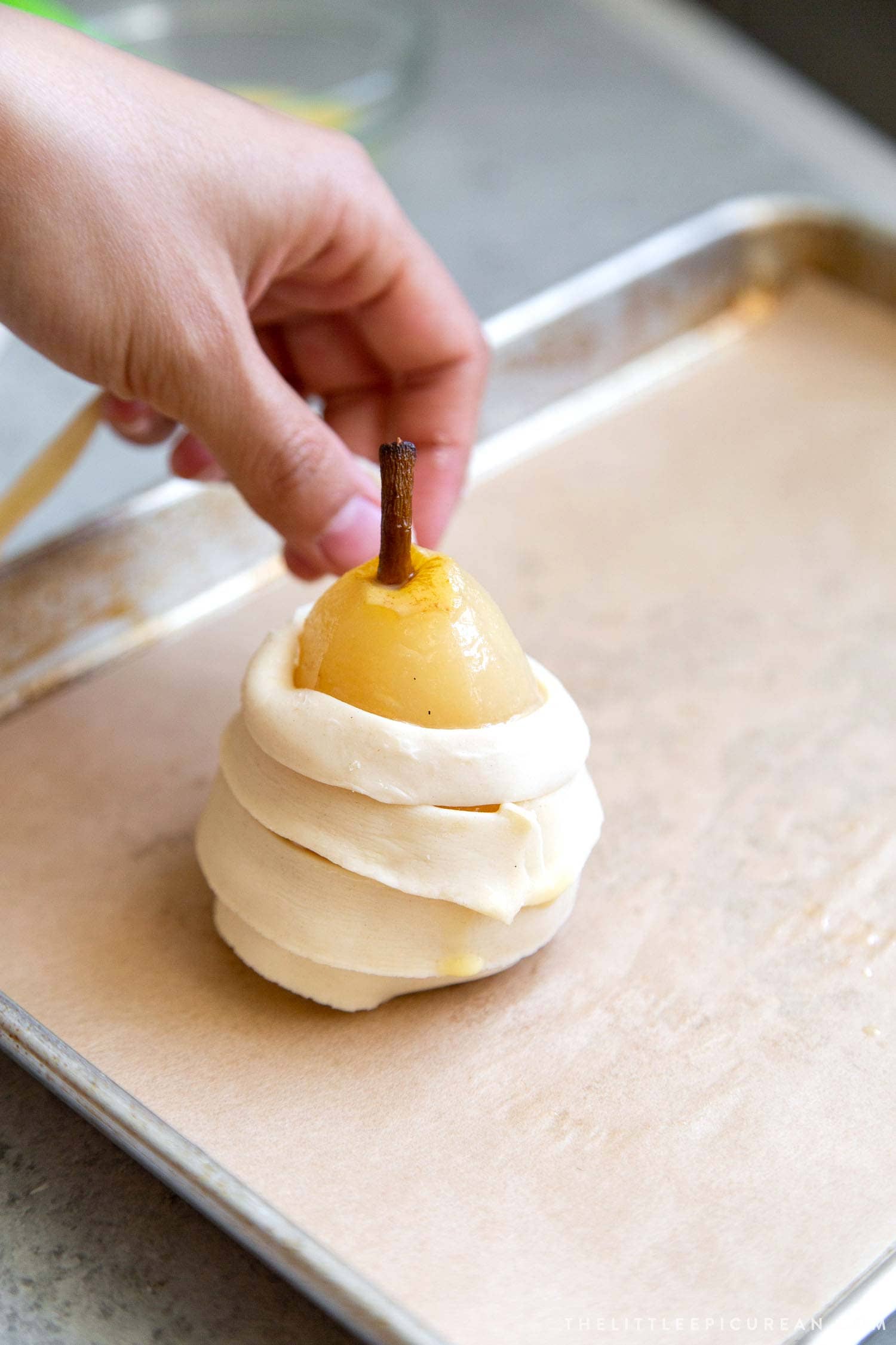 Chilled poached pears encased in puff pastry strips. 