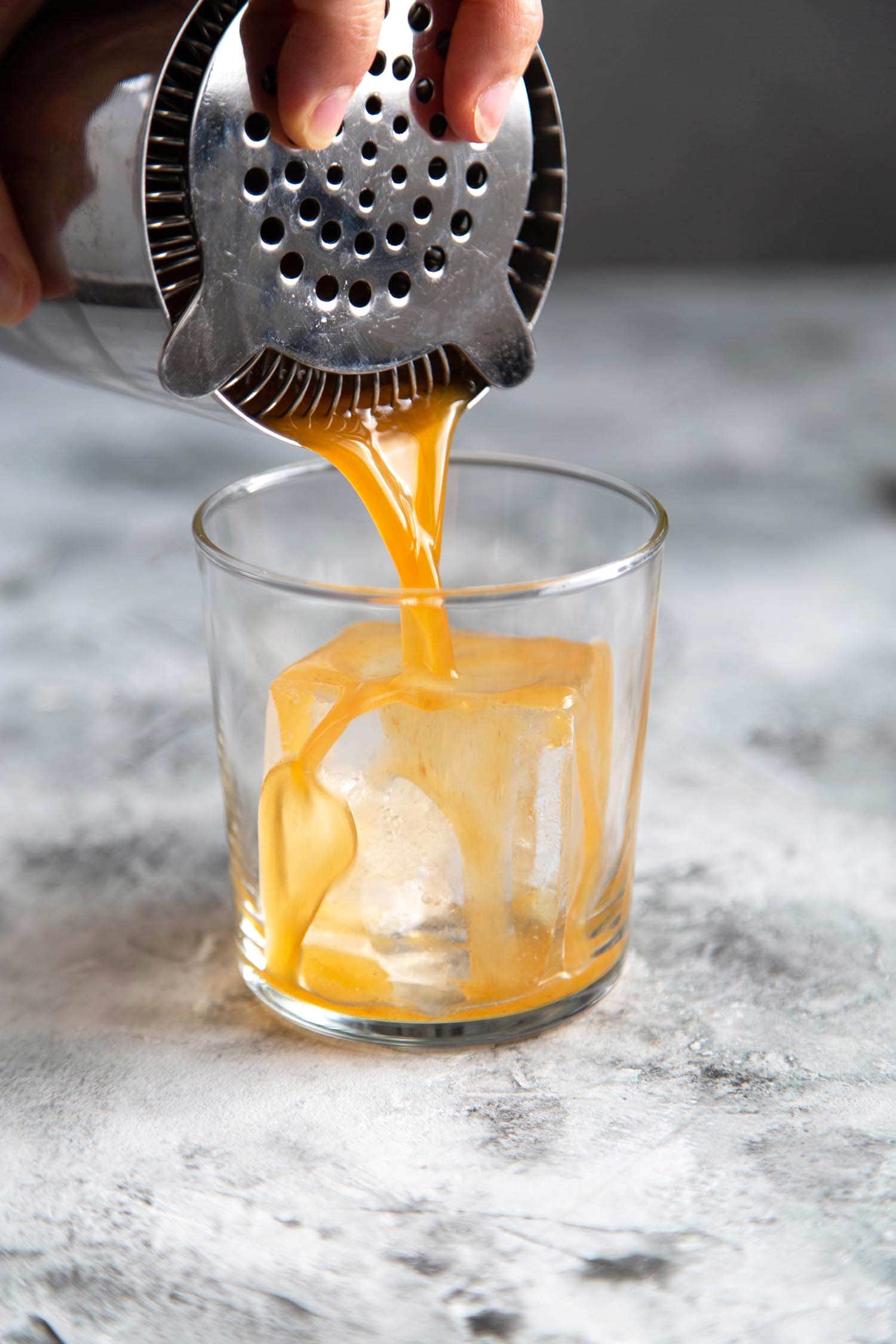 Mix autumn harvest cocktail (pumpkin bourbon cocktail) in a Boston shaker. Then, strain into serving glass.