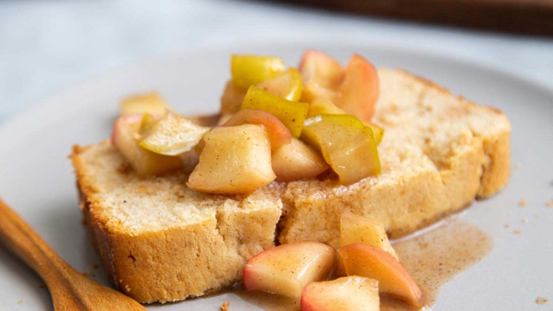 Spiced Apple Pound Cake. Orange scented pound cake topped with cooked spiced apples. #dessert #poundcake #recipe #appledessert