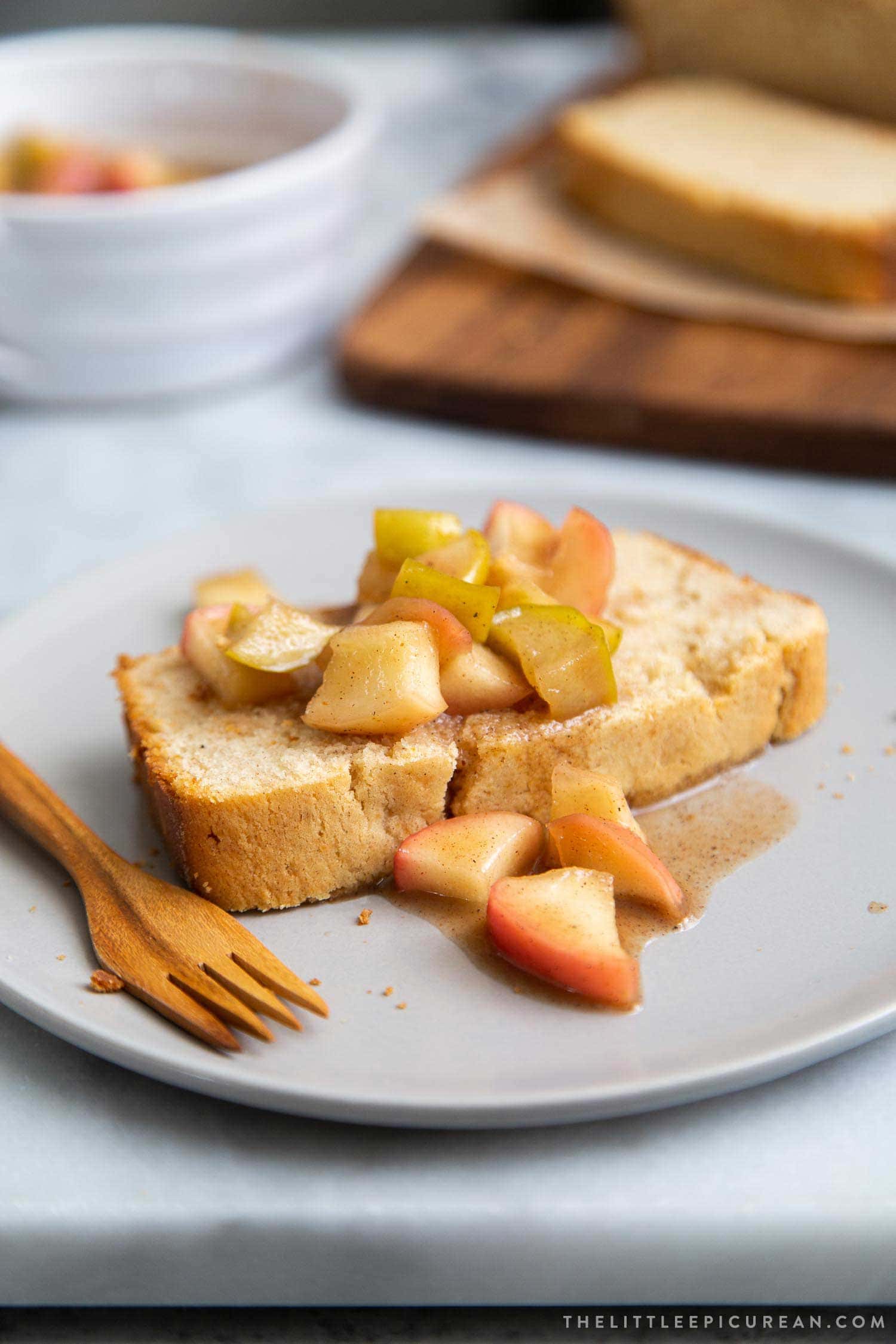 Spiced Apple Pound Cake. Orange scented pound cake topped with cooked spiced apples. #dessert #poundcake #recipe #appledessert