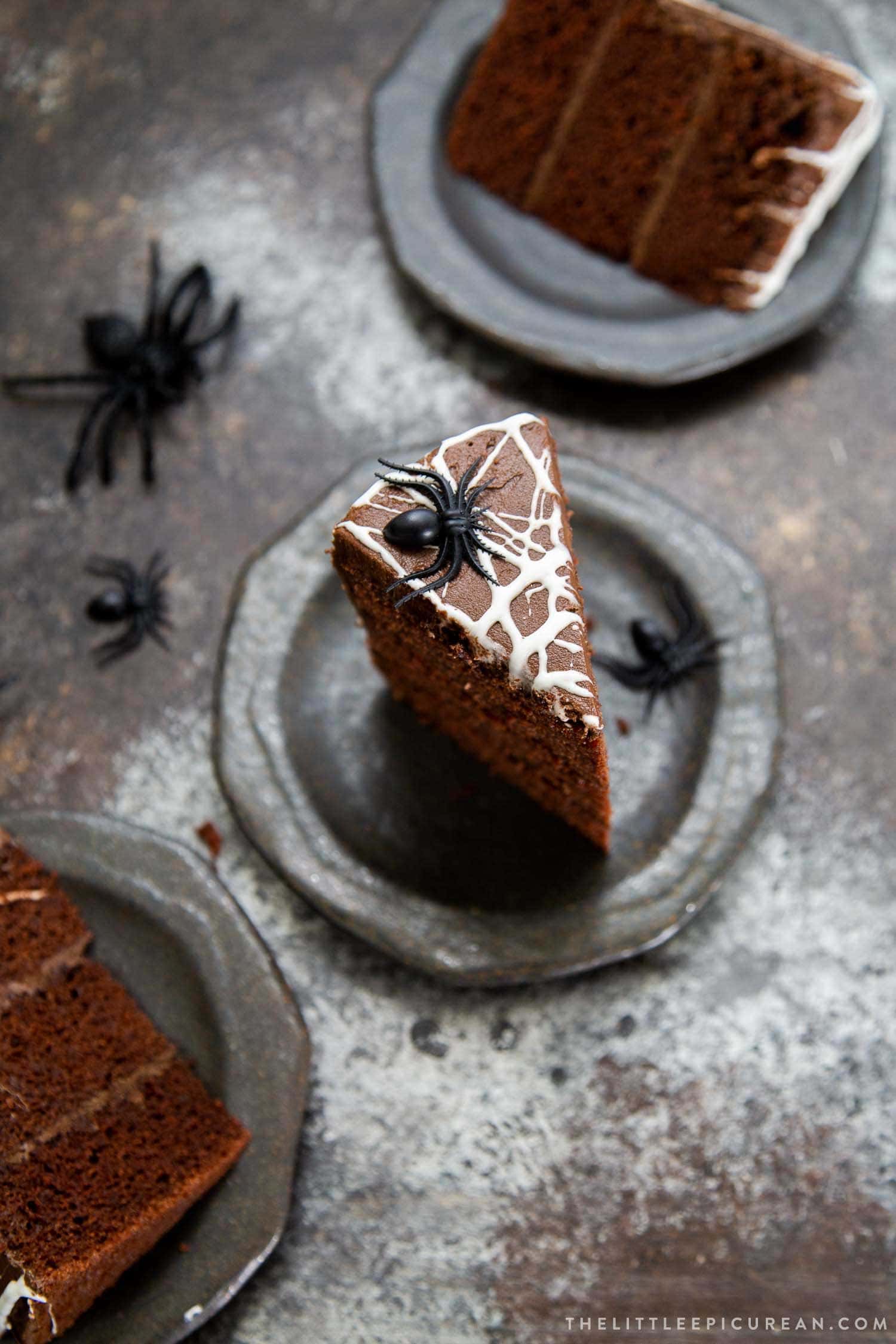 Chocolate Spider Web Cake. Three layer chocolate cake frosted with simple chocolate buttercream and decorated with marshmallow spider webs. It's the perfect Halloween treat!