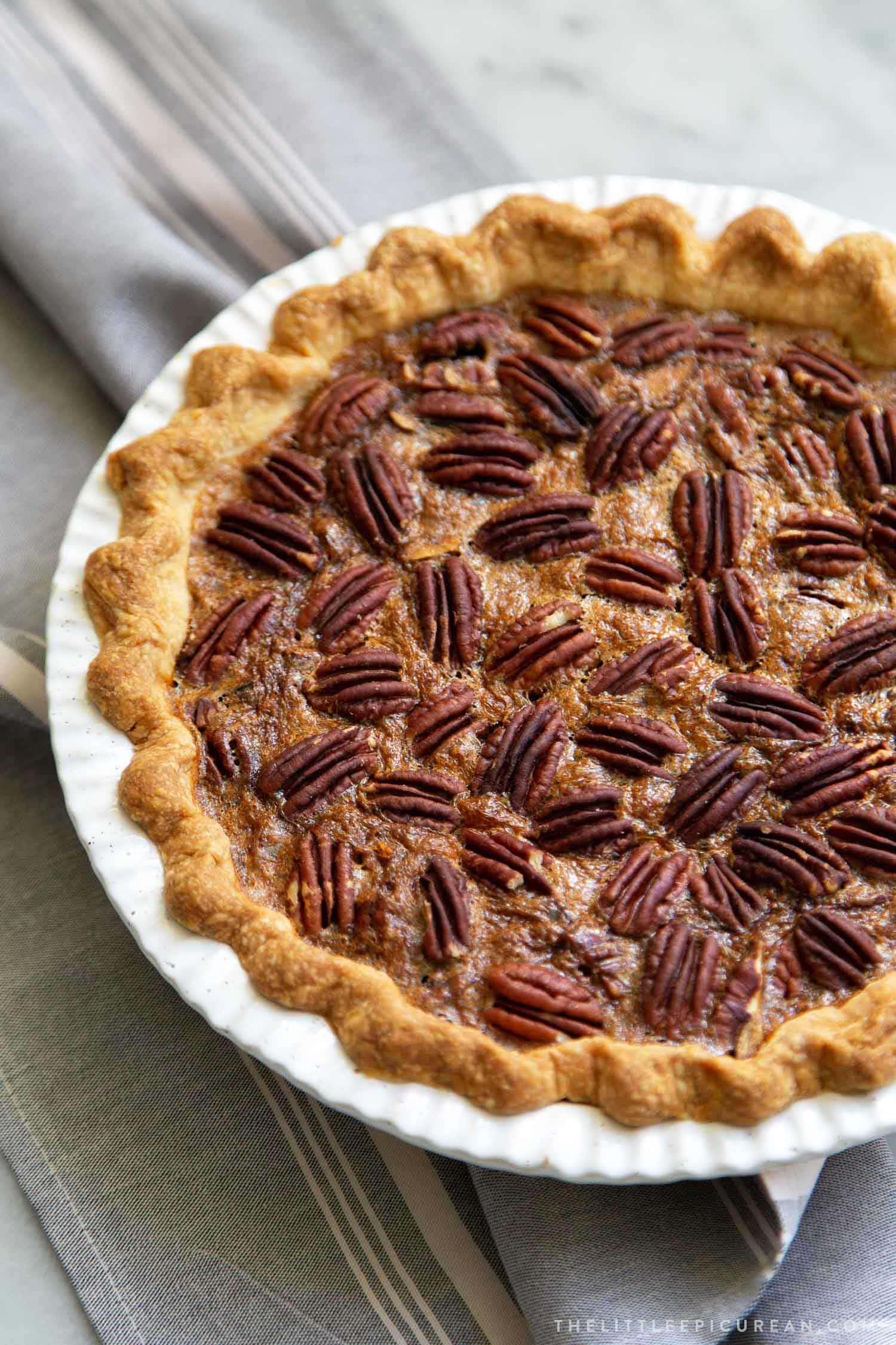 Brown Butter Pecan Pie. Traditional pecan pie with the added warmth and nuttiness of brown butter. This recipe includes a homemade butter pie crust. Perfect for Thanksgiving and beyond! #pecanpie #pie #classicpie #recipe #thanksgiving #holidays #fallbaking