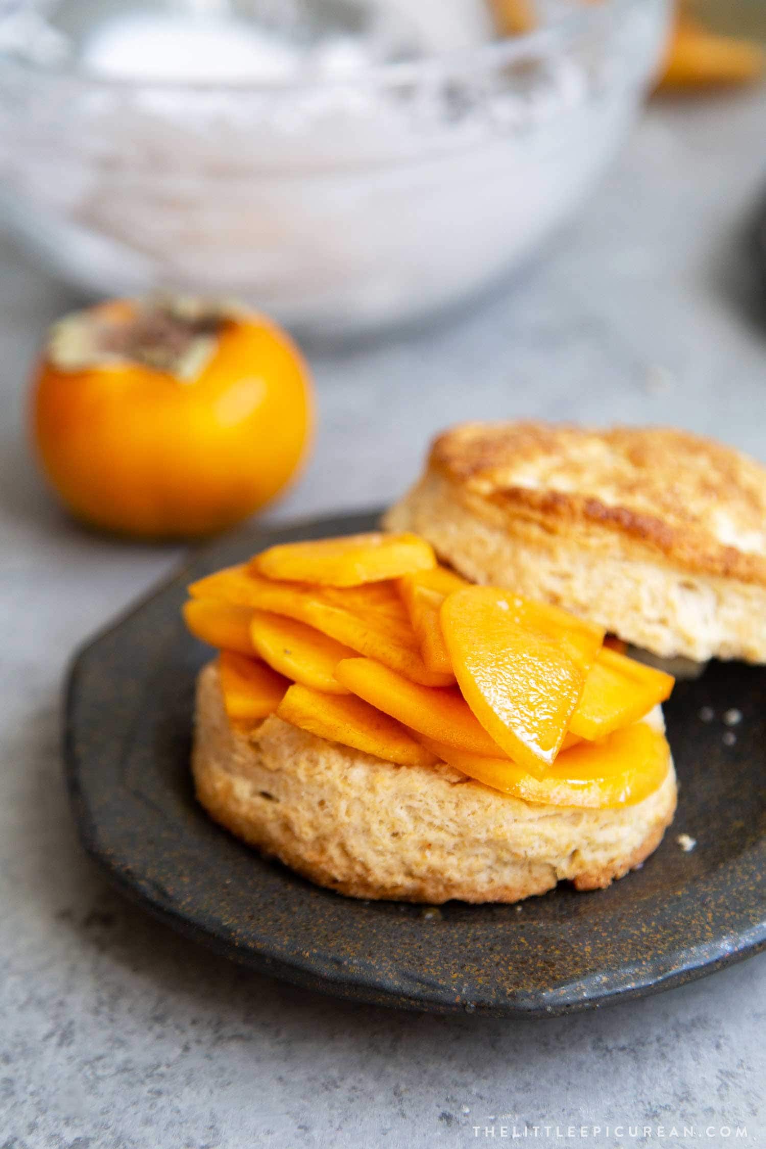 Coconut Persimmon Shortcake. A new spin strawberry shortcake. This dessert features coconut milk shortcake biscuits filled with sliced persimmons and coconut whipped cream. #persimmons #fuyupersimmons #fallbaking #shortcake #biscuits