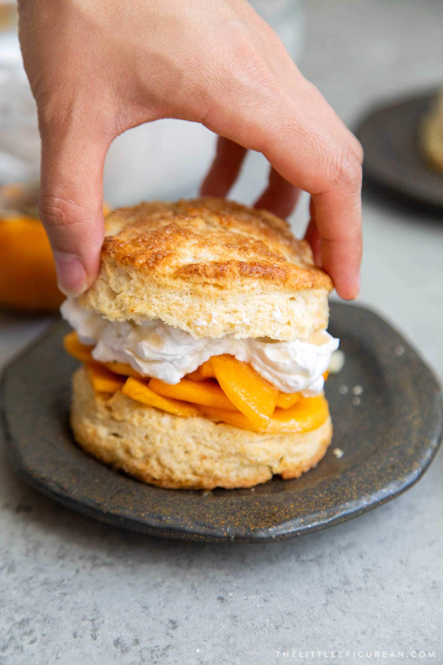 Coconut Persimmon Shortcake. A new spin strawberry shortcake. This dessert features coconut milk shortcake biscuits filled with sliced persimmons and coconut whipped cream. #persimmons #fuyupersimmons #fallbaking #shortcake #biscuits