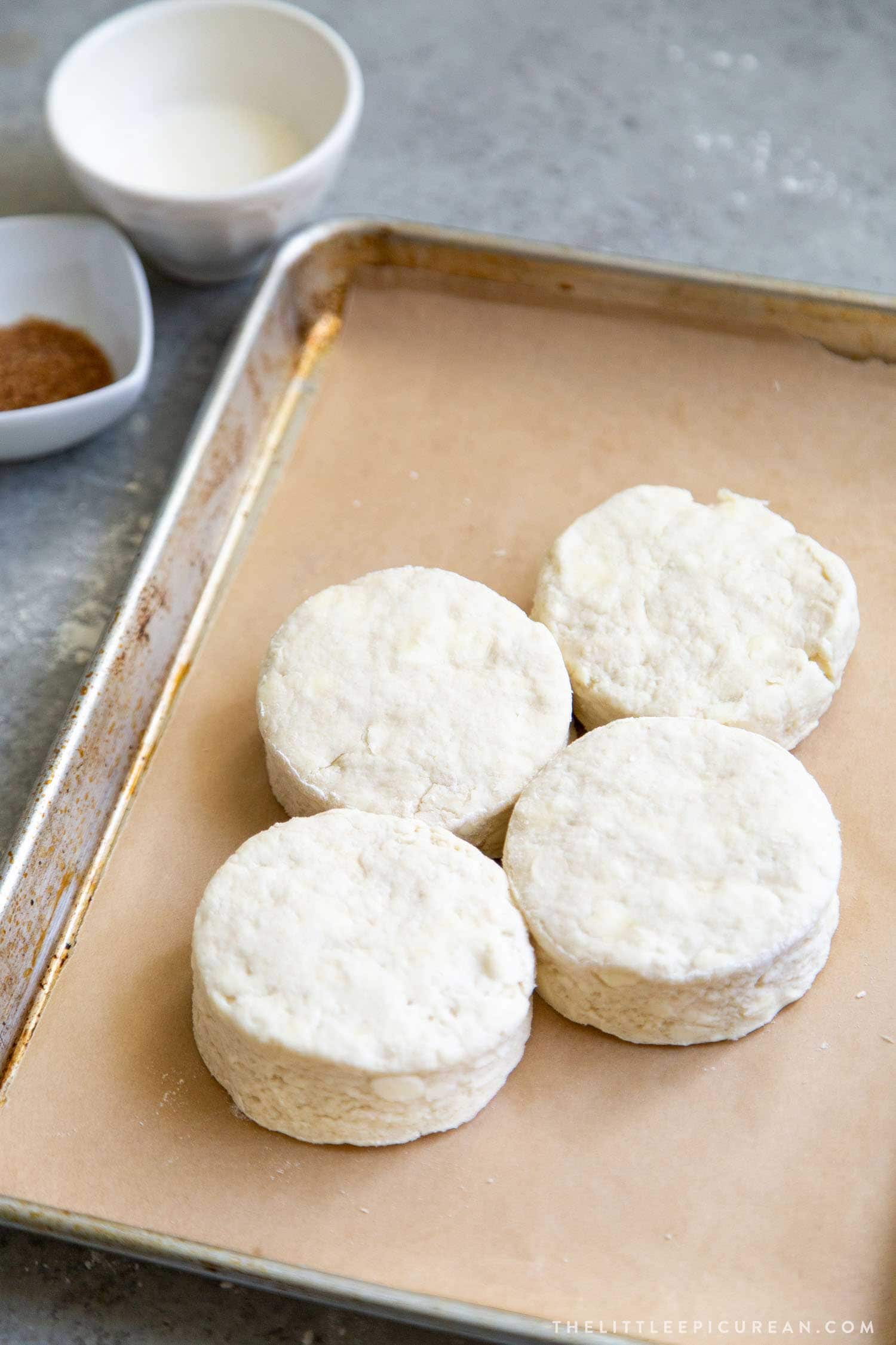 These coconut shortcake biscuits are baked touching each other. This allows the biscuits to rise more during baking.