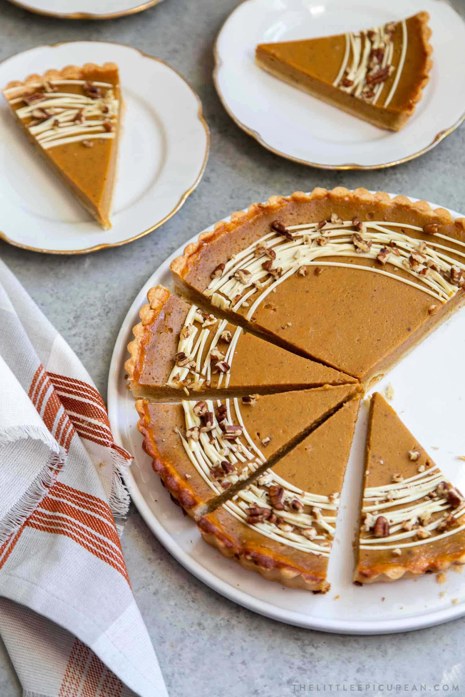 Easy Pumpkin Tart. Tart shell is made with a buttery shortbread crust. The one bowl pumpkin filling is a breeze to a make. It's decorated with melted white chocolate and chopped pecans. #pumpkin #pumpkintart #piesandtarts #dessert #thanksgiving