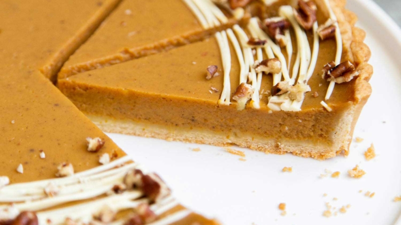 Easy Pumpkin Tart. Tart shell is made with a buttery shortbread crust. The one bowl pumpkin filling is a breeze to a make. It's decorated with melted white chocolate and chopped pecans. #pumpkin #pumpkintart #piesandtarts #dessert #thanksgiving