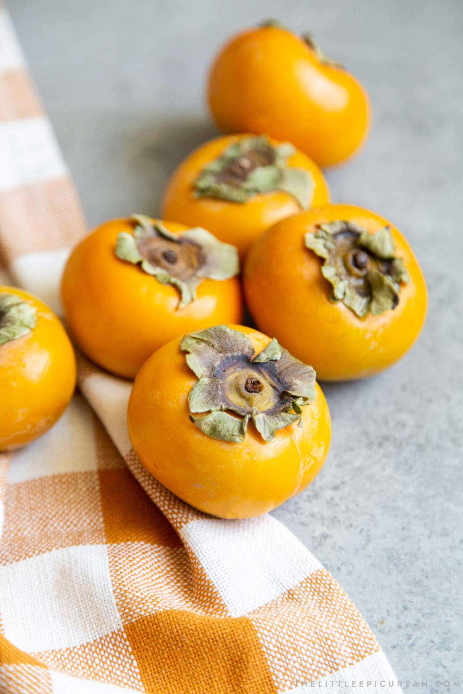 Use Fuyu Persimmons to make coconut persimmon shortcakes. Fuyu is crisp like an apple. Peel the skin and quarter it into wedges. The fuyu is best eaten while it is still firm. 