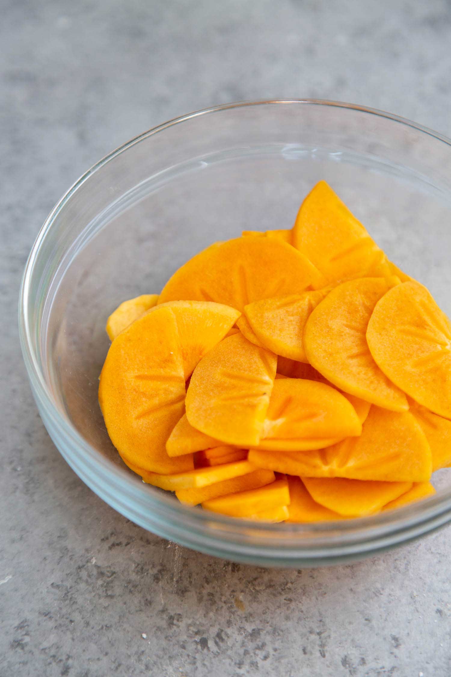 Use Fuyu Persimmons to make coconut persimmon shortcakes. Fuyu is crisp like an apple. Peel the skin and quarter it into wedges. The fuyu is best eaten while it is still firm.