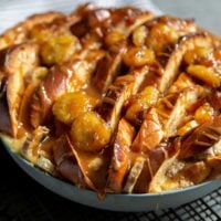 Banana Foster Bread Pudding. Sliced challah bread soaked in spiced custard mixture, baked until golden, and topped with brown sugar cooked bananas and caramel sauce. #breakfast #brunch #breadpudding #dessert #sweet