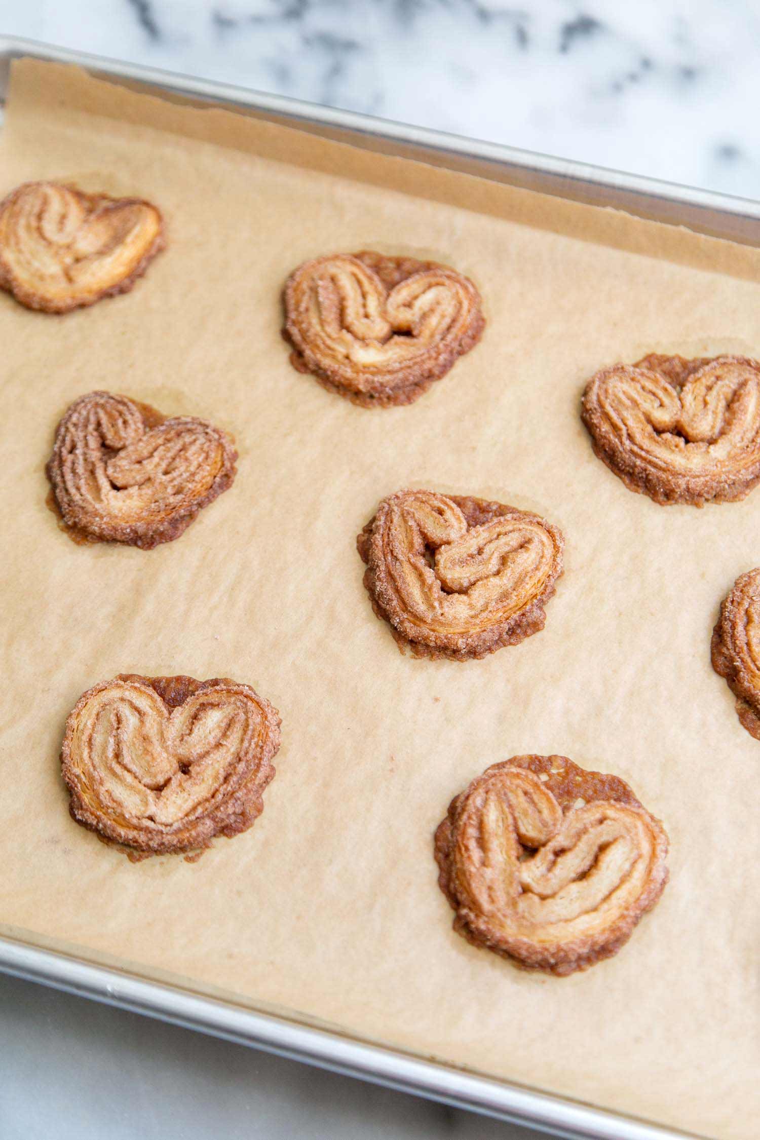 Cinnamon Sugar Palmiers. During baking, the frozen cookies will spread out and form little hearts. #cinnamonsugar #cookies #palmiers #easyrecipe