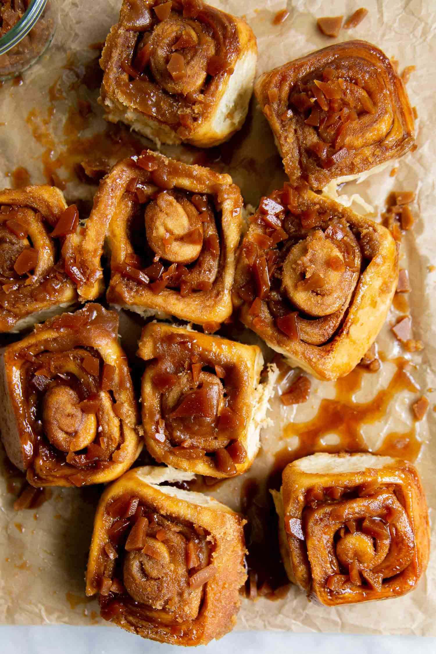 Toffee Sticky Buns. These warm and fluffy buns are filled with cinnamon sugar, coated with a sweet molasses glaze, and topped with chopped toffee bits! #breakfast #brunch #holidays #toffee #stickybuns