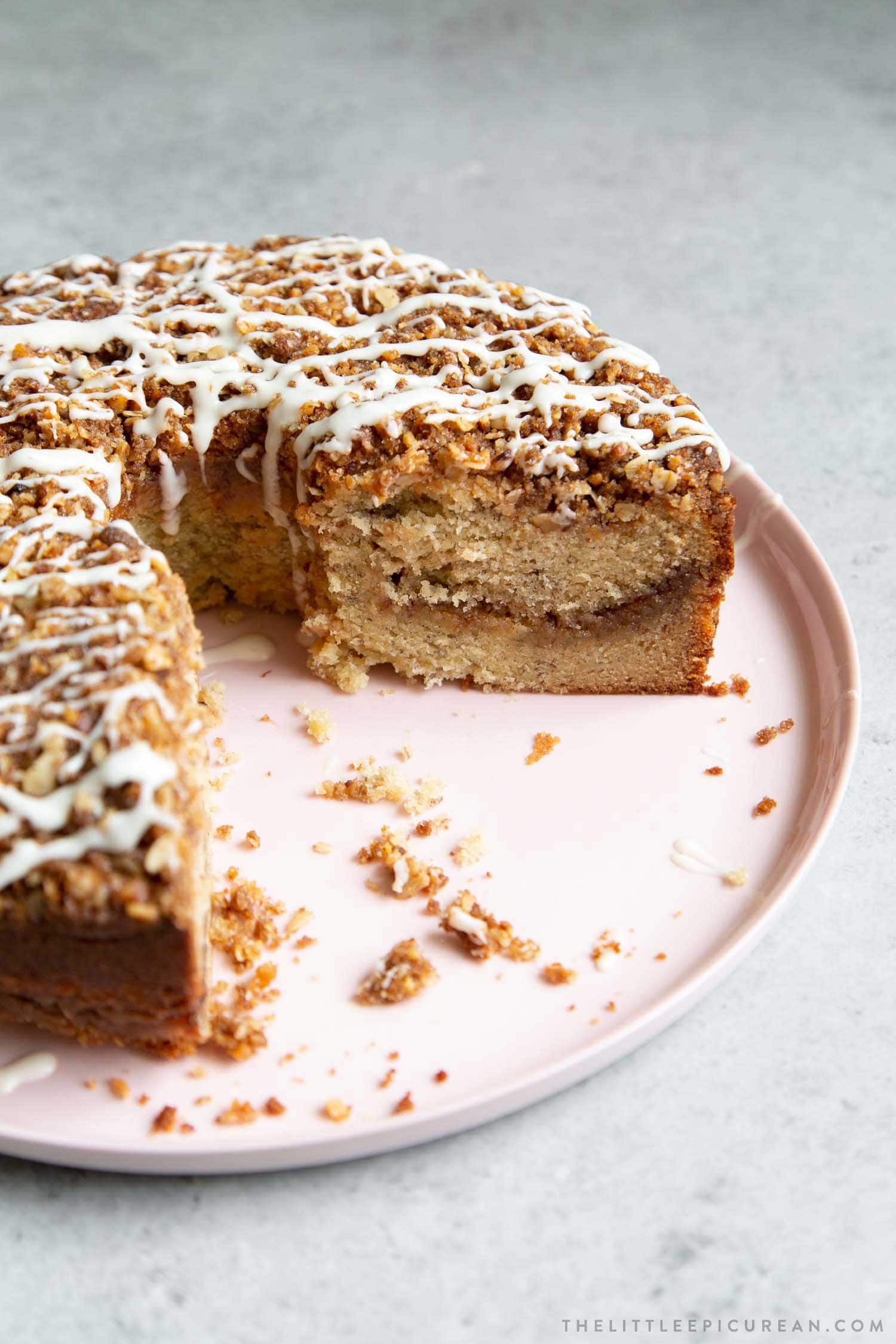 Banana Crumb Cake. Moist banana cake with cinnamon sugar filling topped with walnut oat crumble topping. Banana Crumb Cake. Moist banana cake with cinnamon sugar filling topped with walnut oat crumble topping. Finished with maple glaze icing.