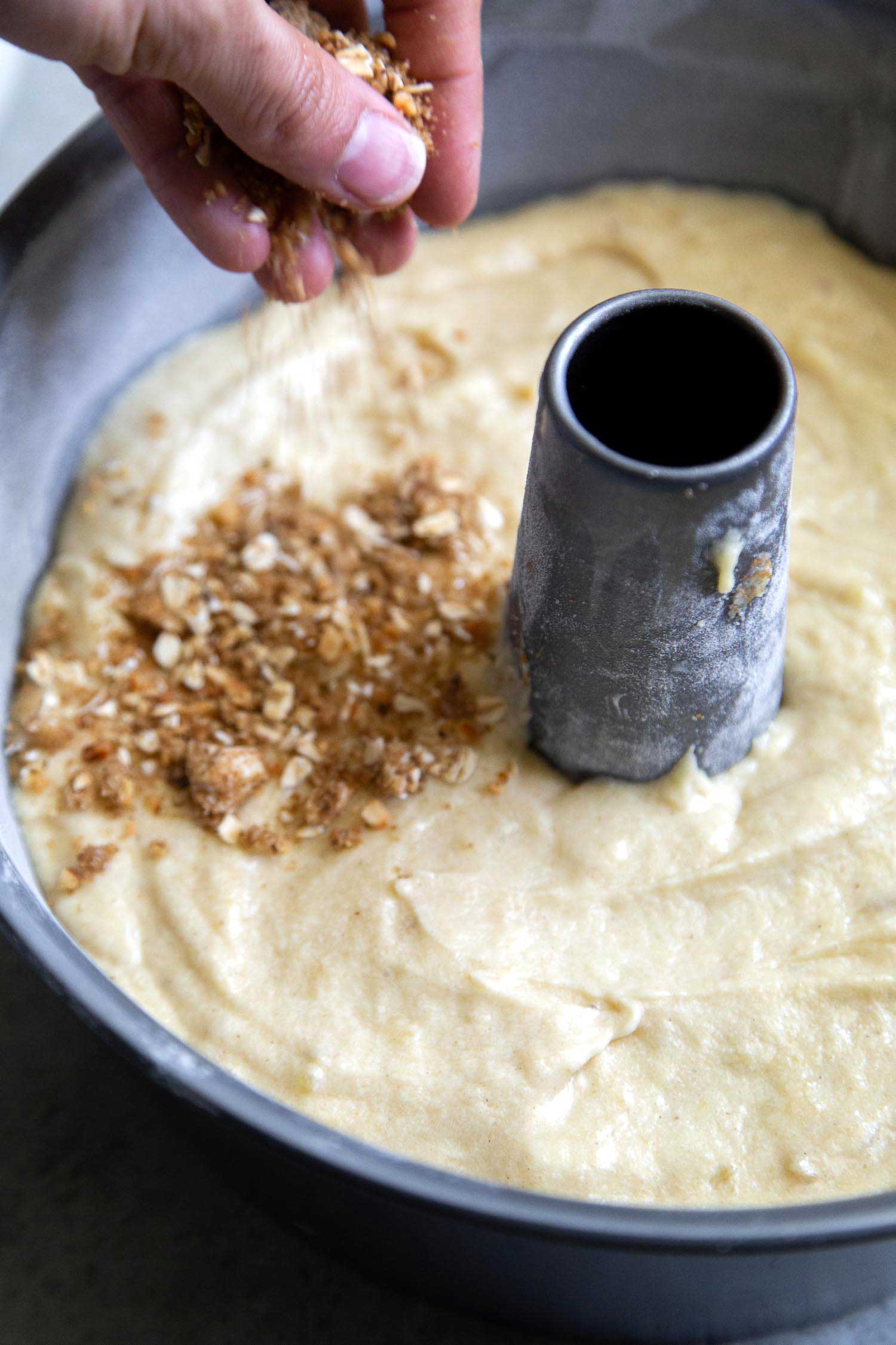 Banana cake batter topped with with walnut oat crumble. Banana crumb cake baked in tube pan.