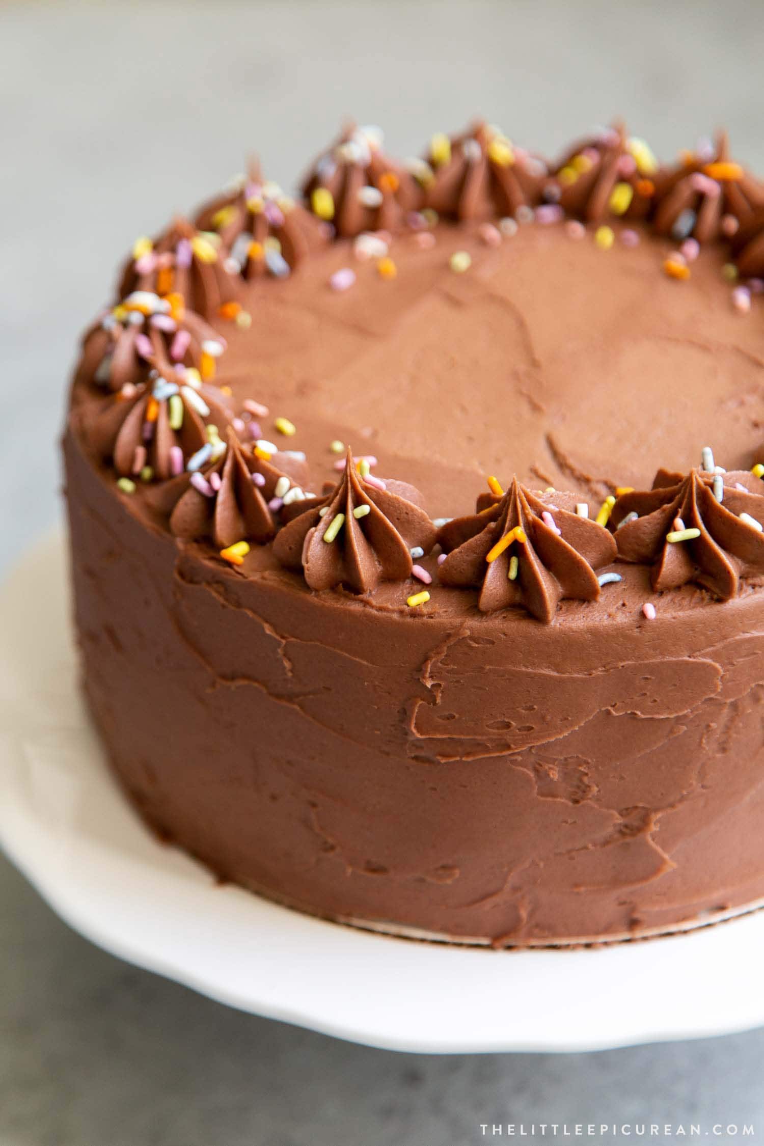 Classic Chocolate Cake. This recipe makes a two layer 8-inch cake or a three layer 6-inch cake. It is frosted with a simple chocolate American buttercream and decorated with rainbow sprinkles.