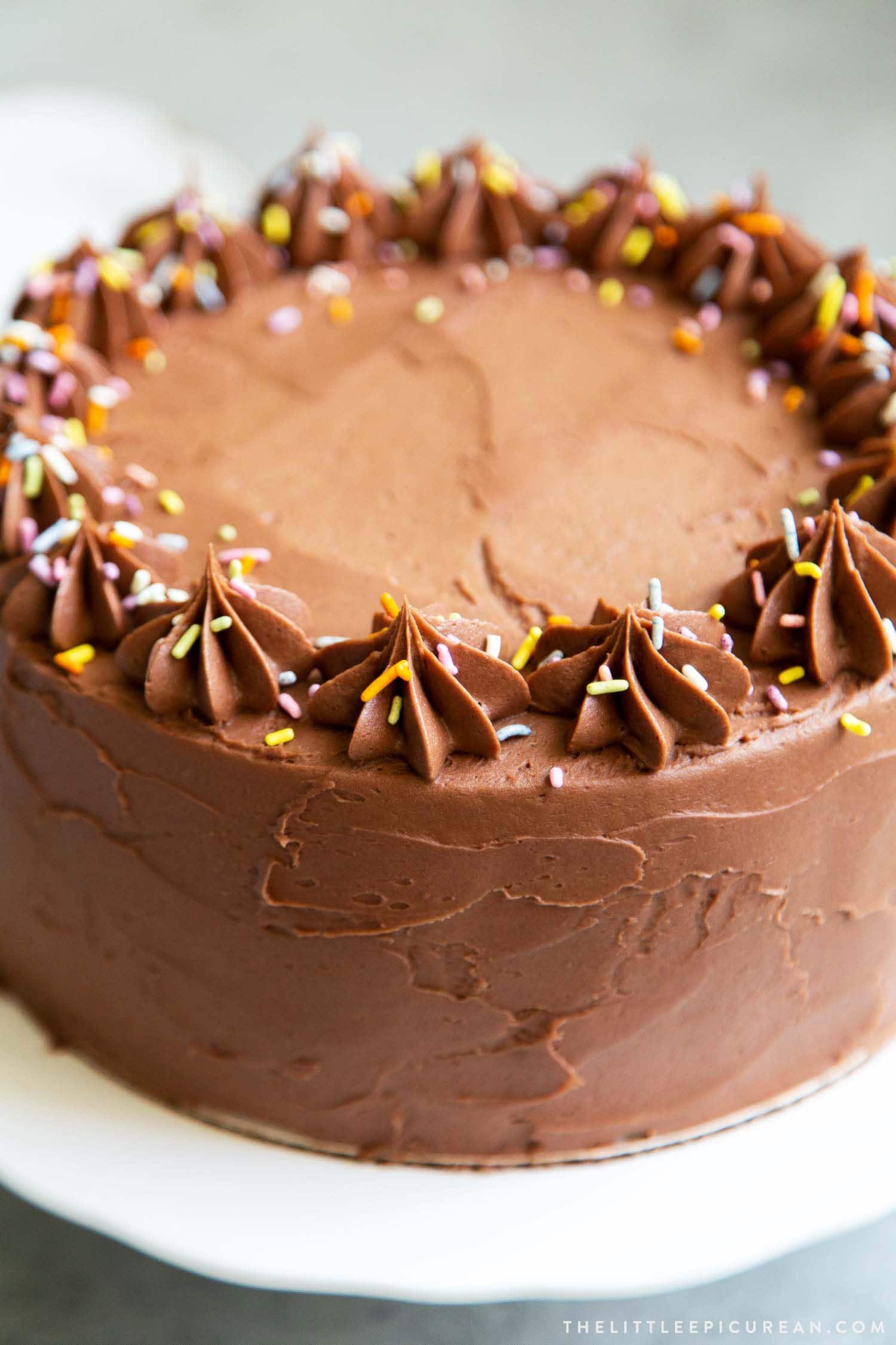 Classic Chocolate Cake. This recipe makes a two layer 8-inch cake or a three layer 6-inch cake. It is frosted with a simple chocolate American buttercream and decorated with rainbow sprinkles. 