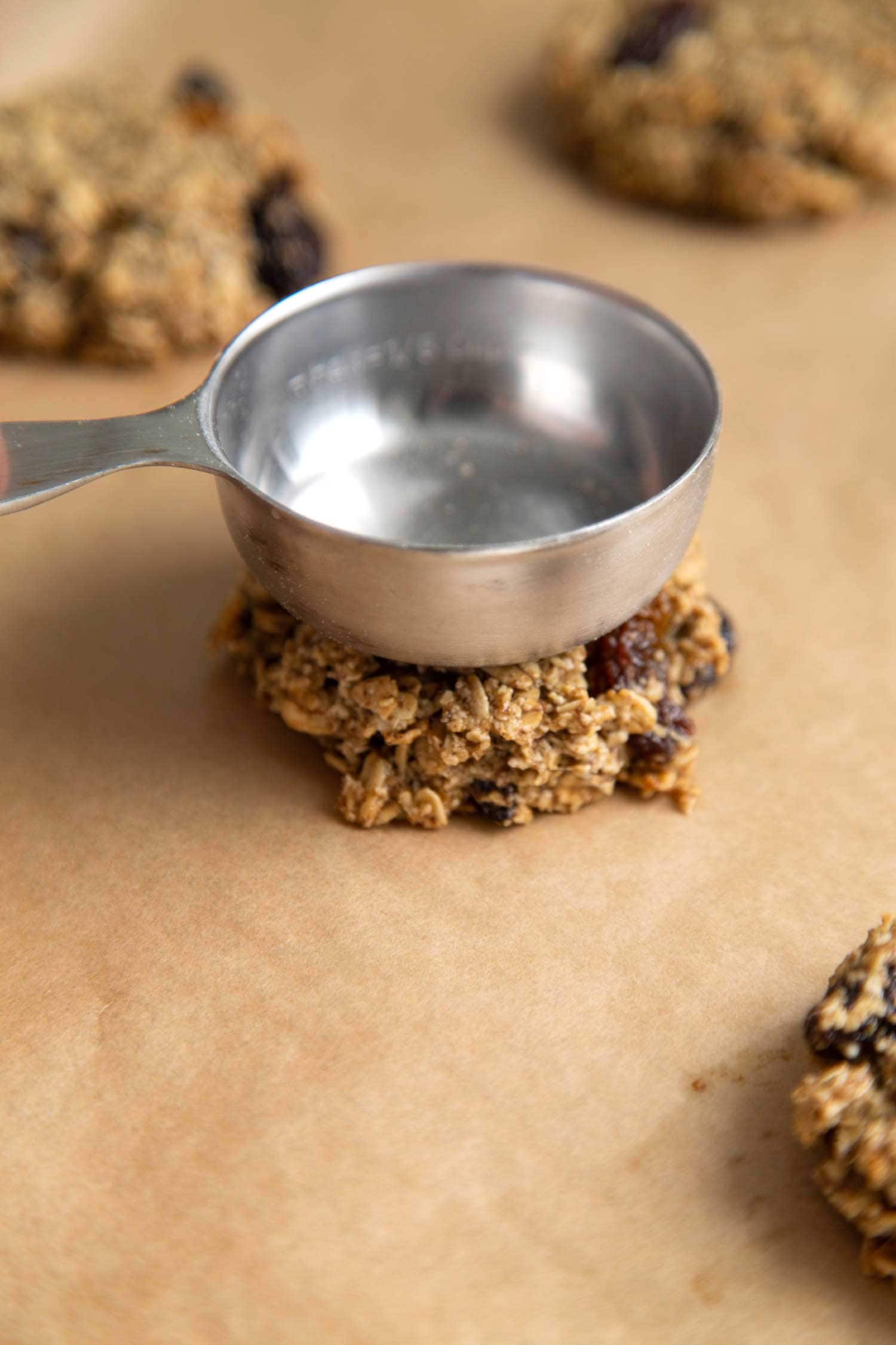 Flatten vegan oatmeal raisin cookie dough before baking