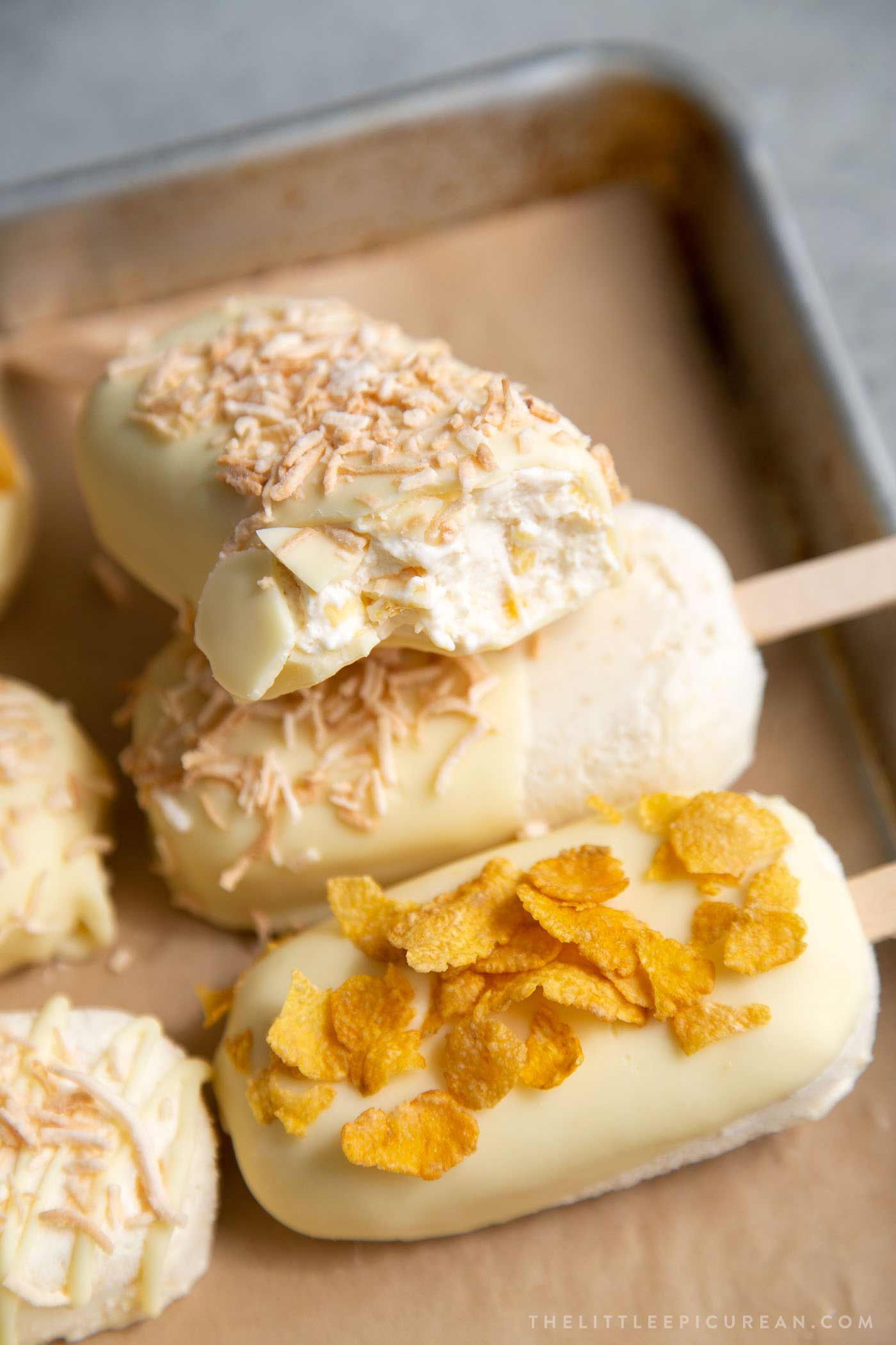 White chocolate dipped corn ice cream topped with corn flakes and shredded coconut