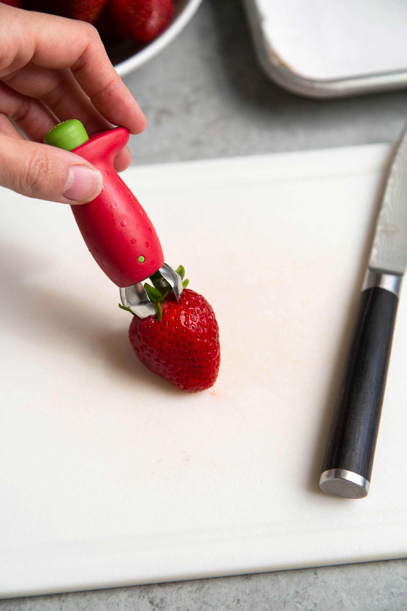 Use a strawberry huller to quickly and easily remove hull and stems