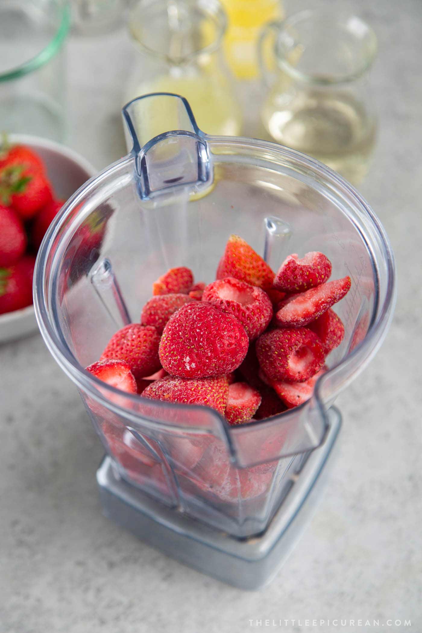 Make frozen strawberry daiquiri in a blender