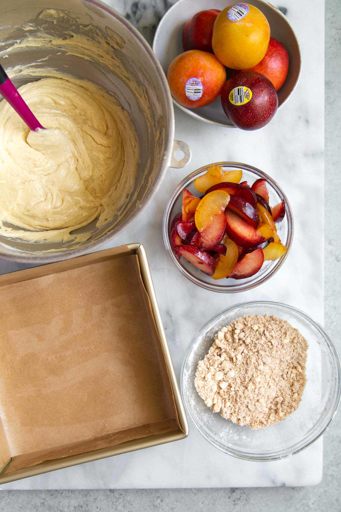 Plumcot Crumb Cake featuring vanilla cake with sliced plumcots and spiced crumble topping