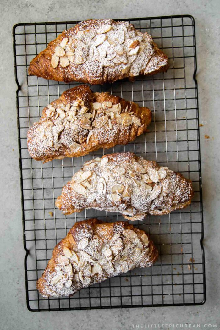 sugar dusted almond croissant on wire rack. 