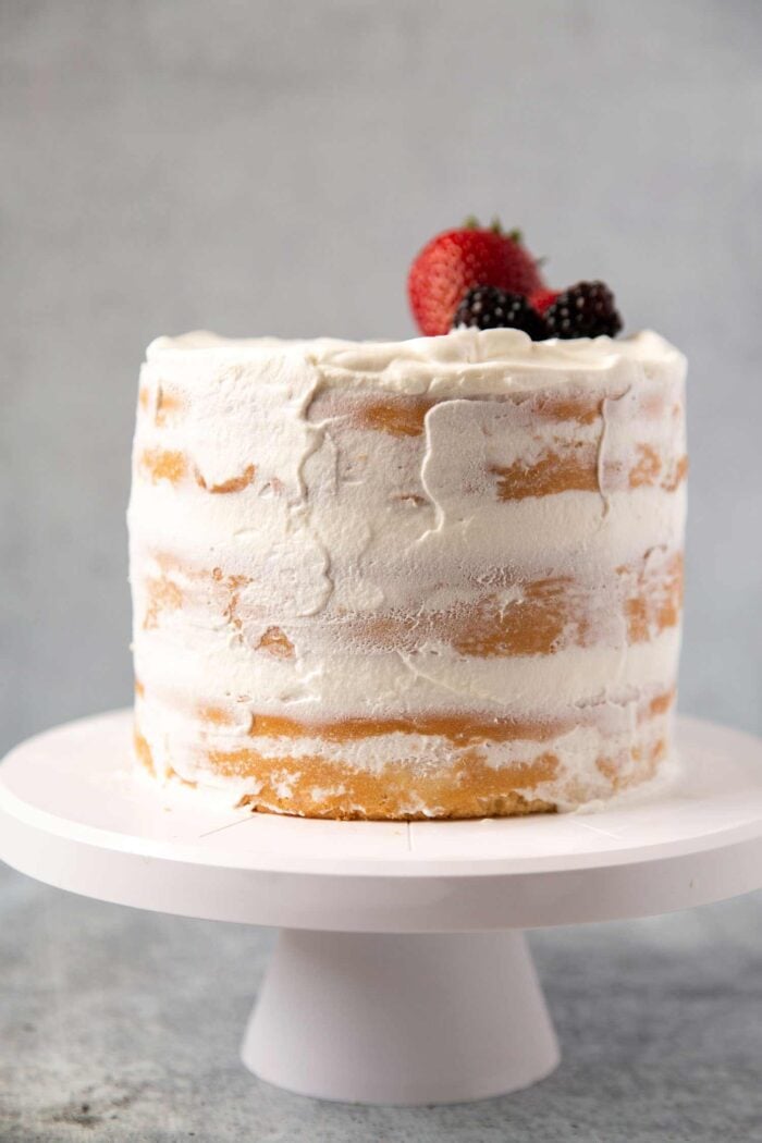 naked coconut cake with whipped cream frosting