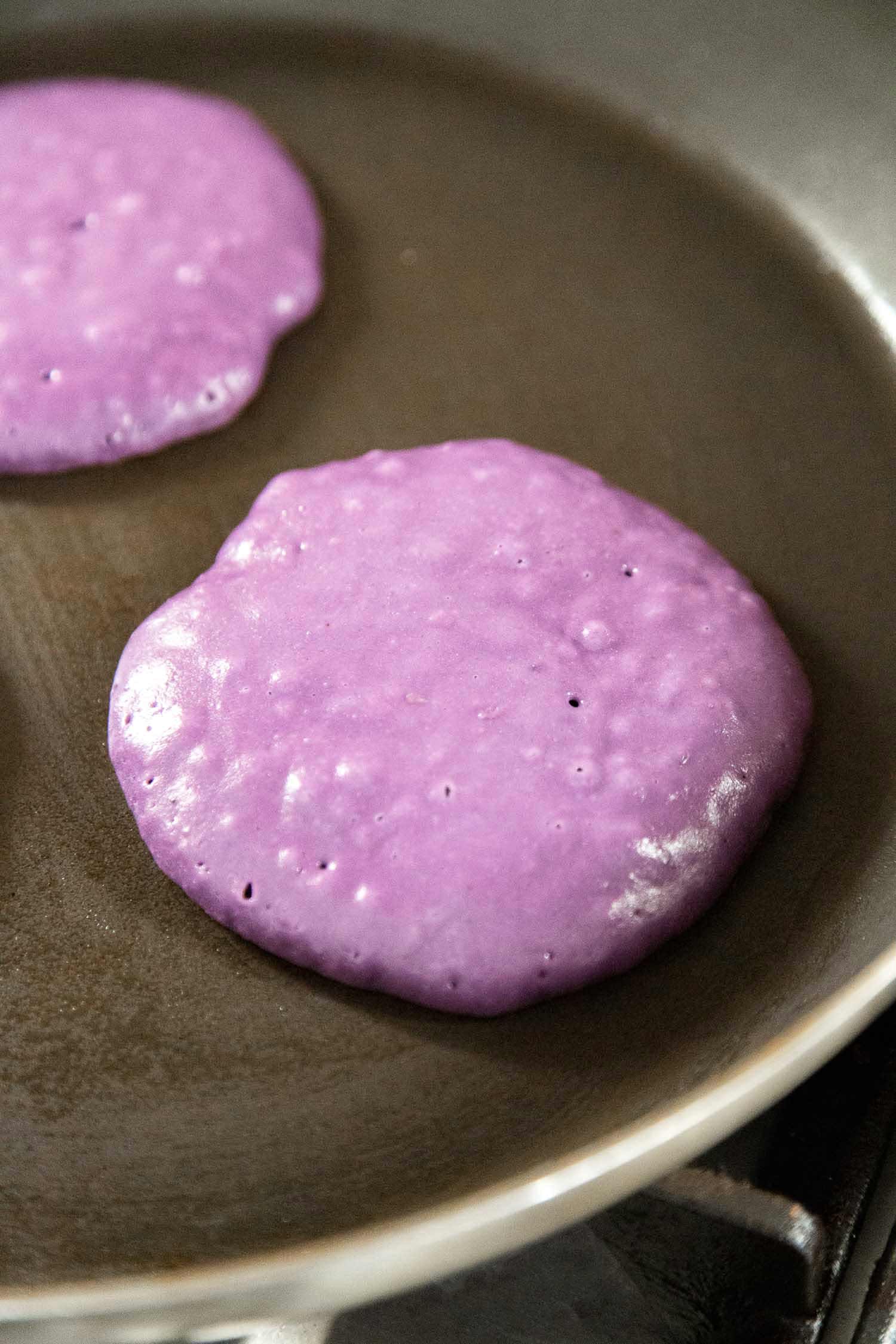 ube pancake batter cooked on nonstick skillet