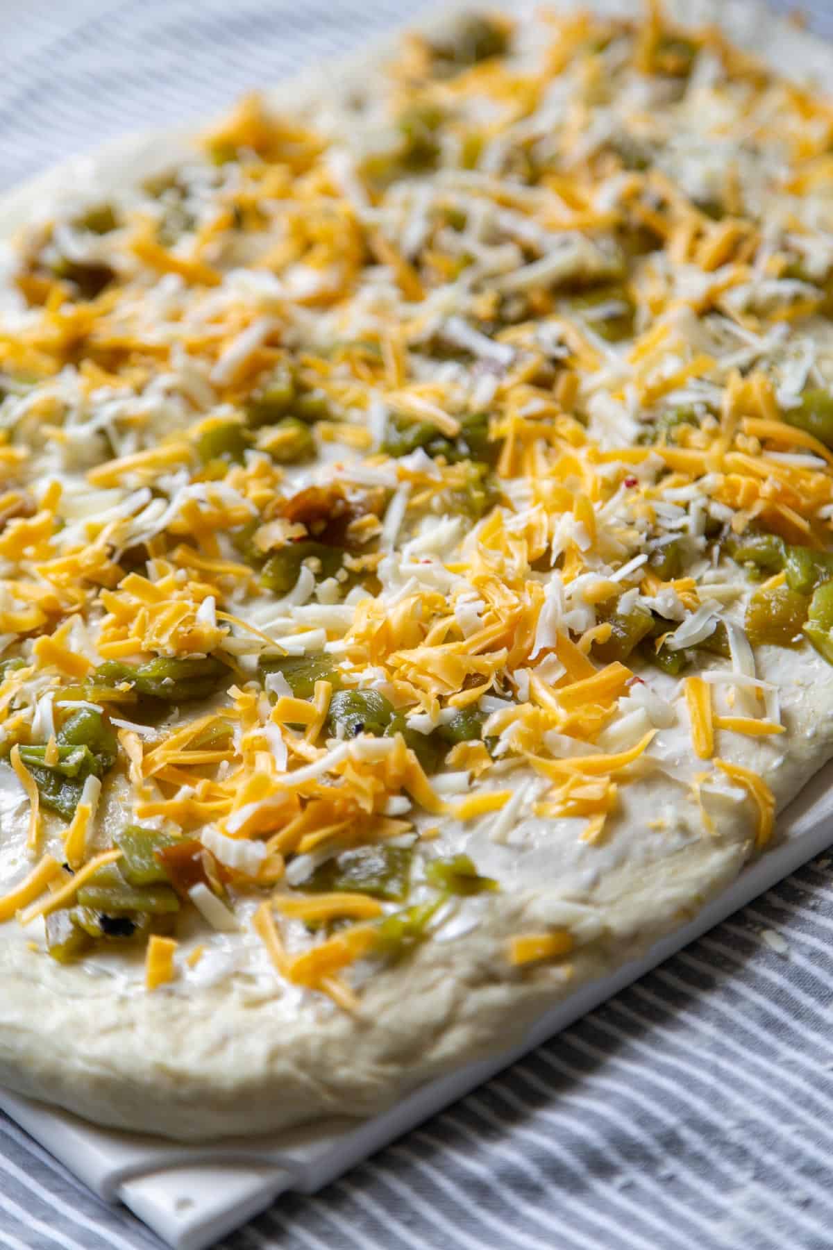 yeast bread topped with softened butter, chopped New Mexico green chile, and shredded cheese.