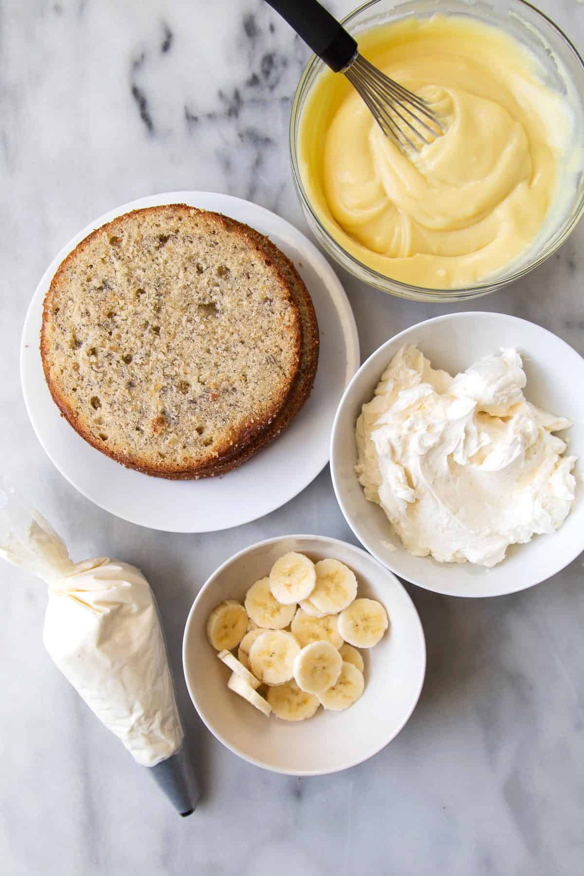 Banana Cream Cake components include pastry cream, sliced bananas, and banana cake layers