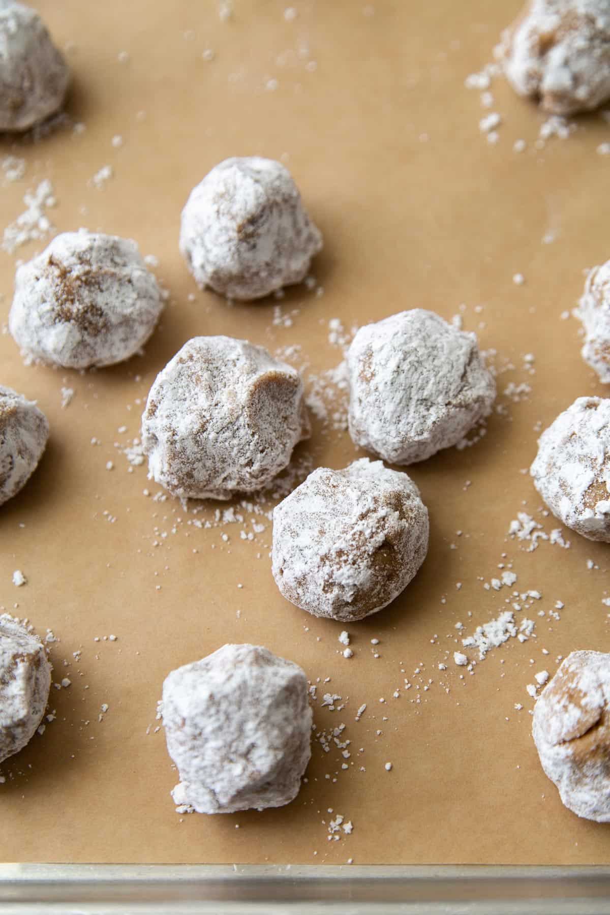 cashew cookies rolled in powdered sugar before baking