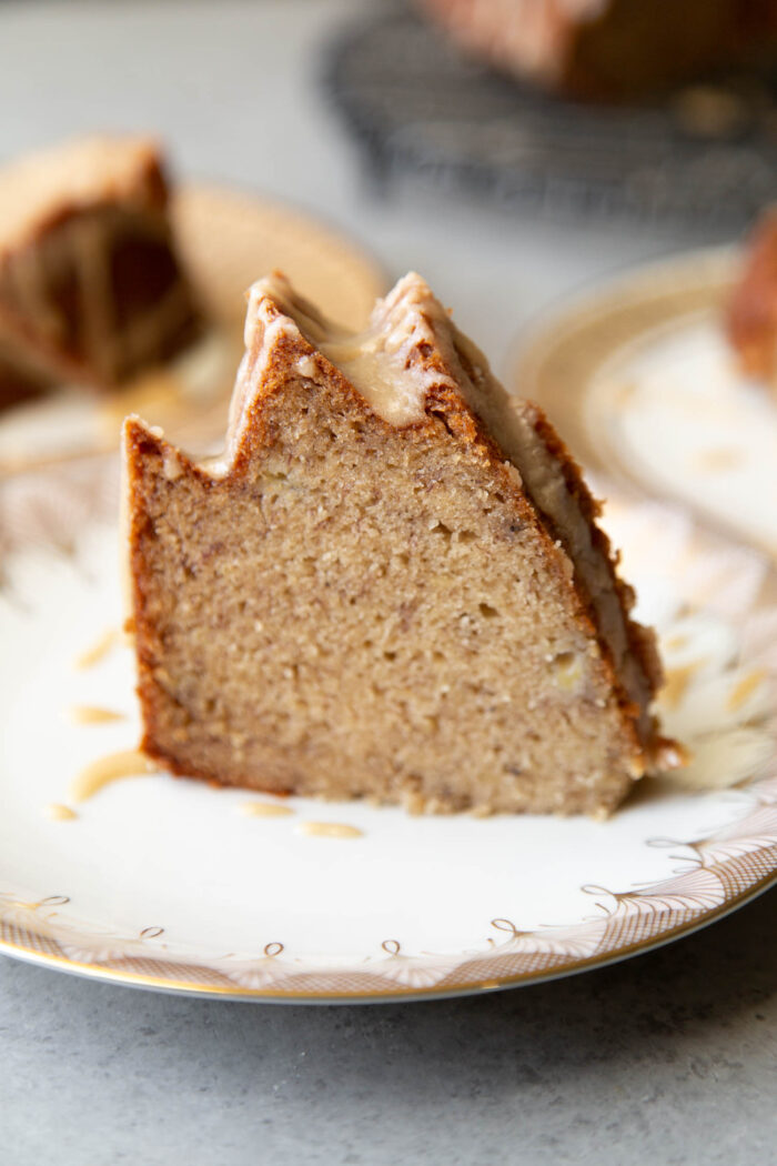 slice of banana bundt cake with brown sugar glaze