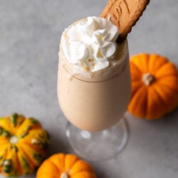 pumpkin milkshake topped with whipped cream and biscoff cookie