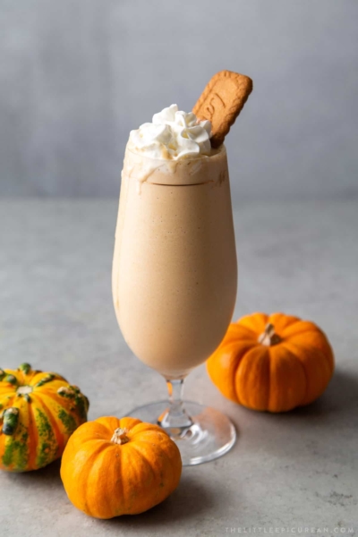 pumpkin milkshake topped with whipped cream and cookie
