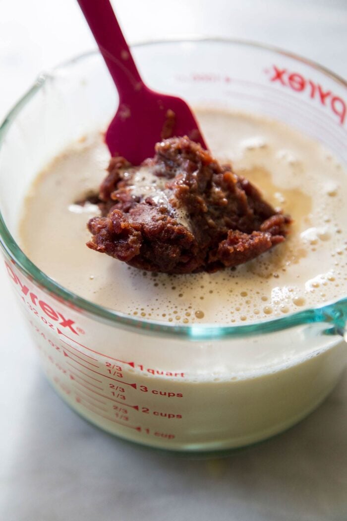 sweetened red bean paste being added to ice cream base.