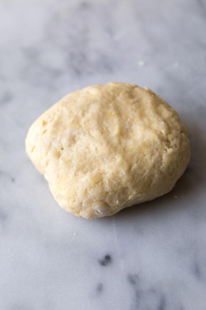 butter pie dough on marble slab.