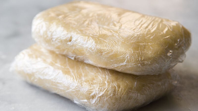 double crust pie dough wrapped in plastic.