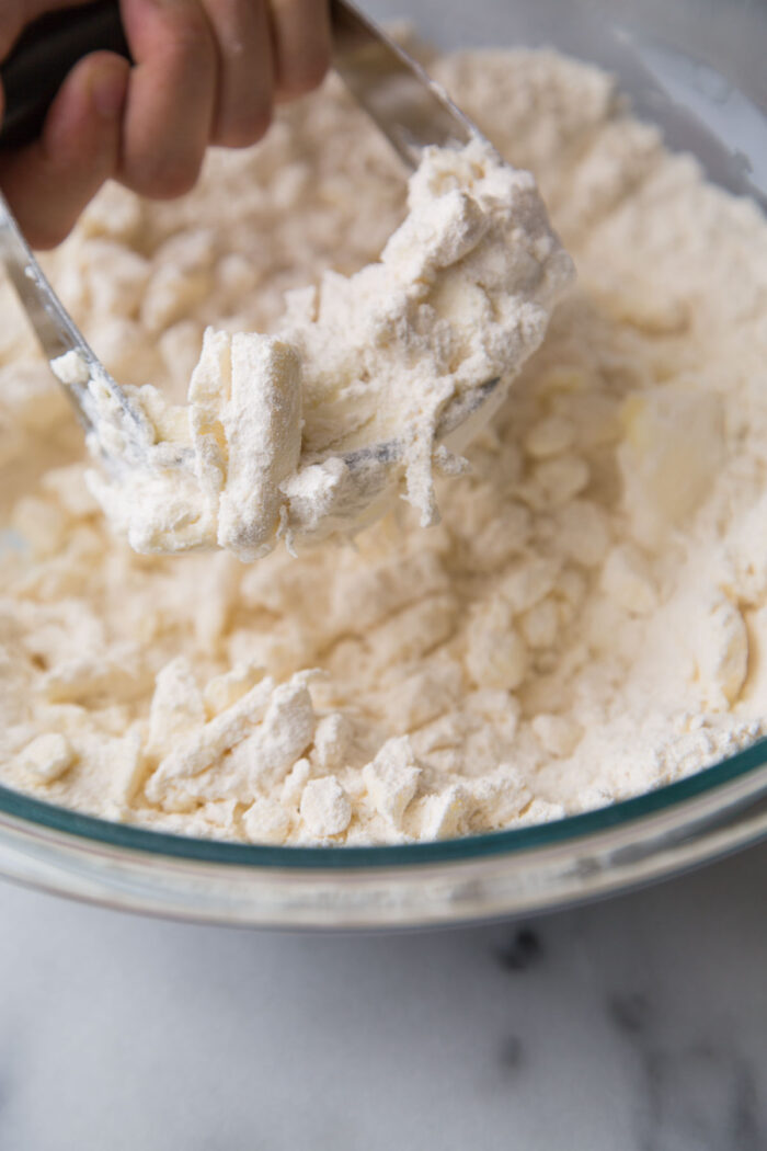 using pastry blender tool to cut butter.