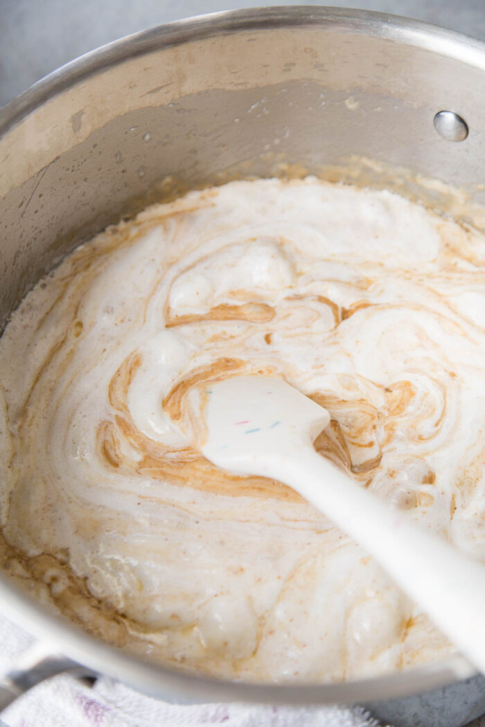 melted marshmallow, butter, and biscoff spread in a saucepot.