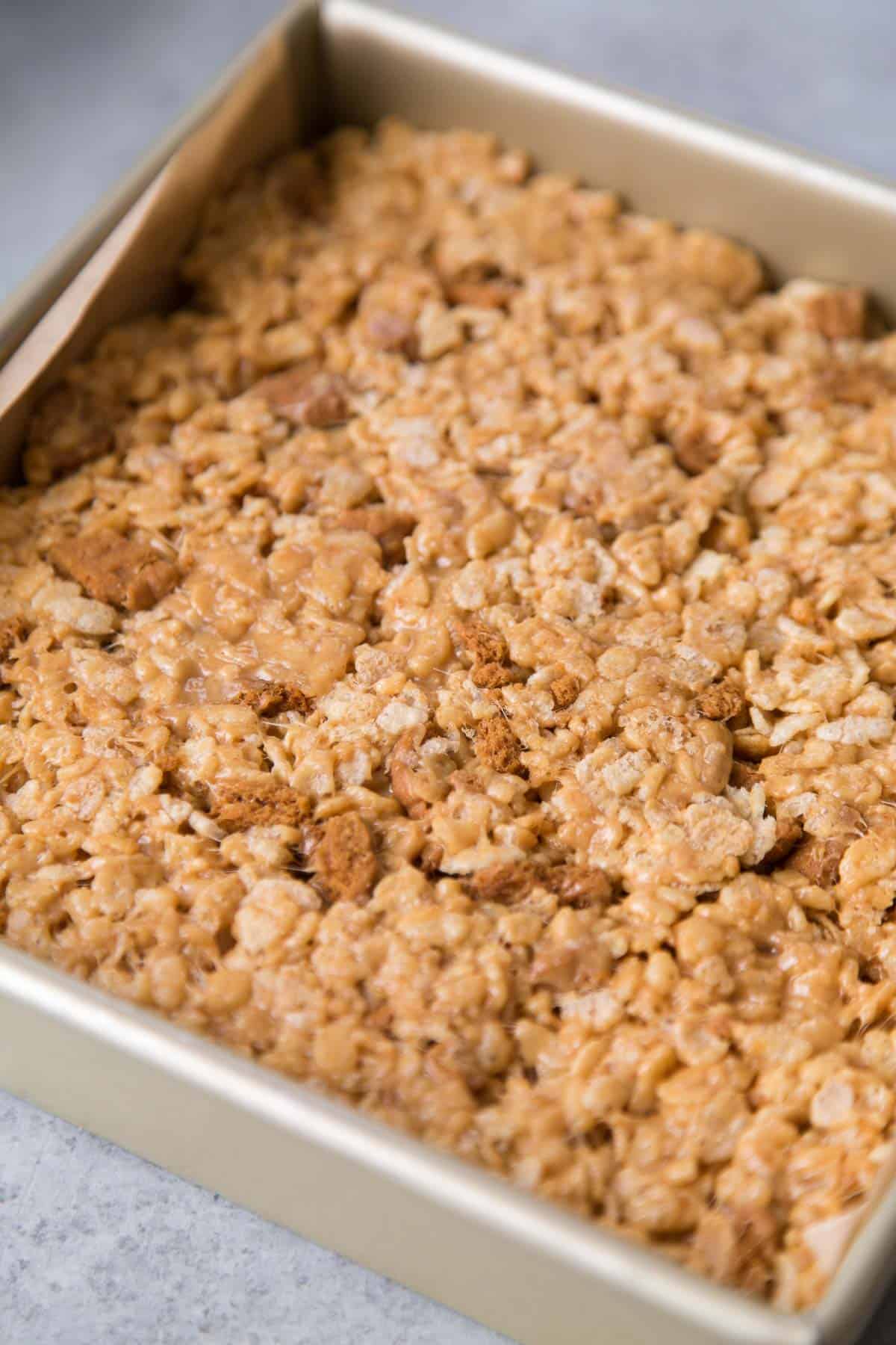 packed biscoff rice krispies treats in 8-inch baking pan.