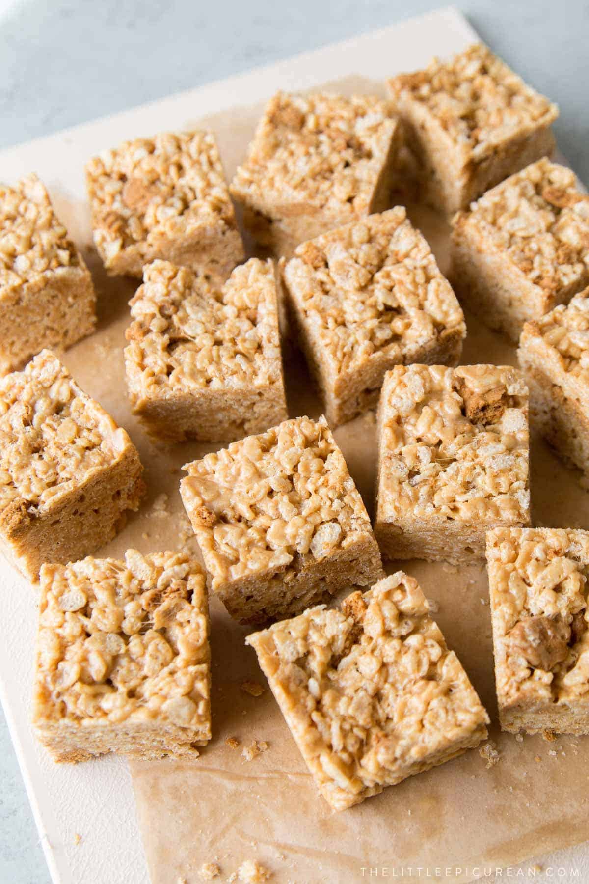 biscoff rice krispies cereal treats cut into square portions.