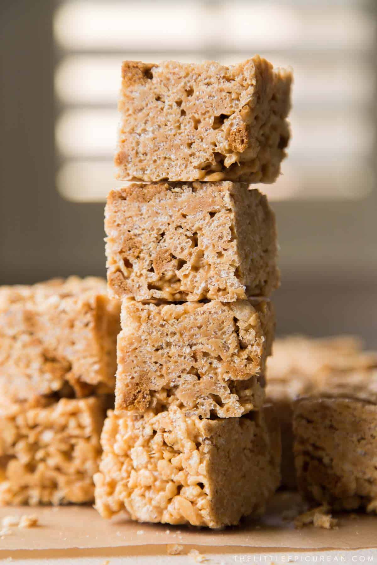 four pieces of biscoff rice krispie treats stacked tall.