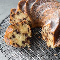 sliced chocolate chip bundt cake on black wire rack.