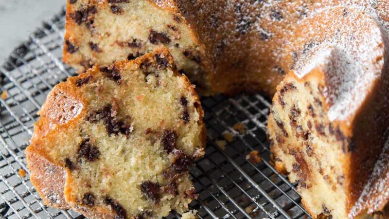 sliced chocolate chip bundt cake on black wire rack.