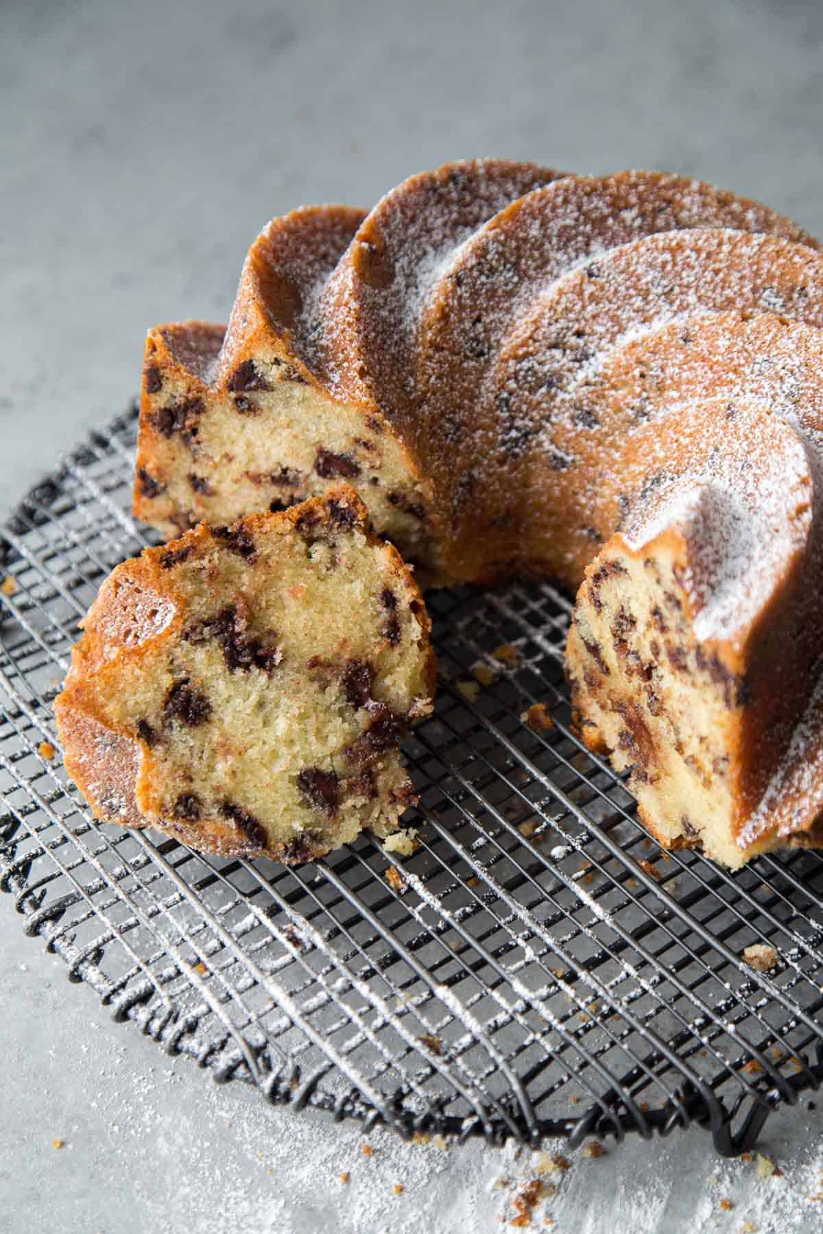 sliced chocolate chip bundt cake on black wire rack. 