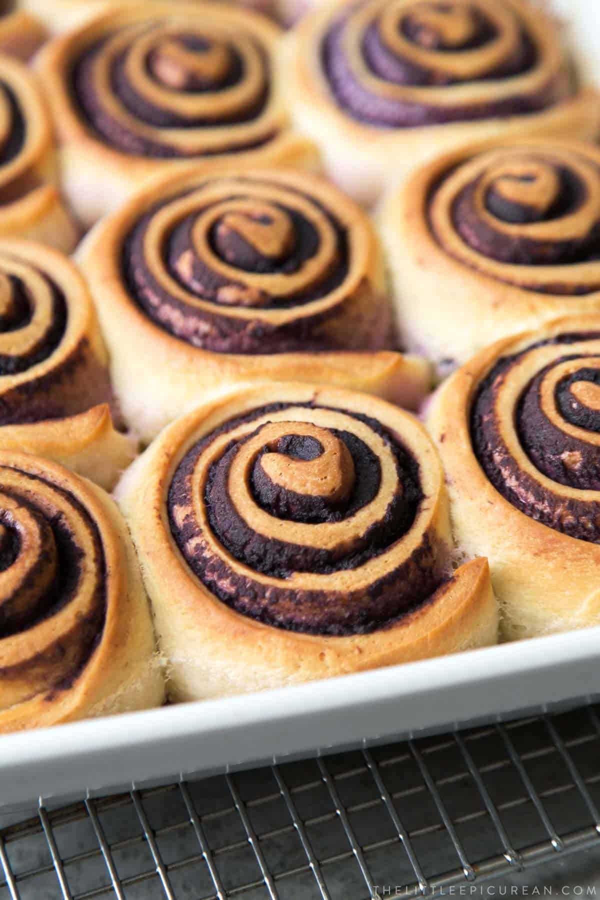 close up of baked ube bread rolls before frosting.