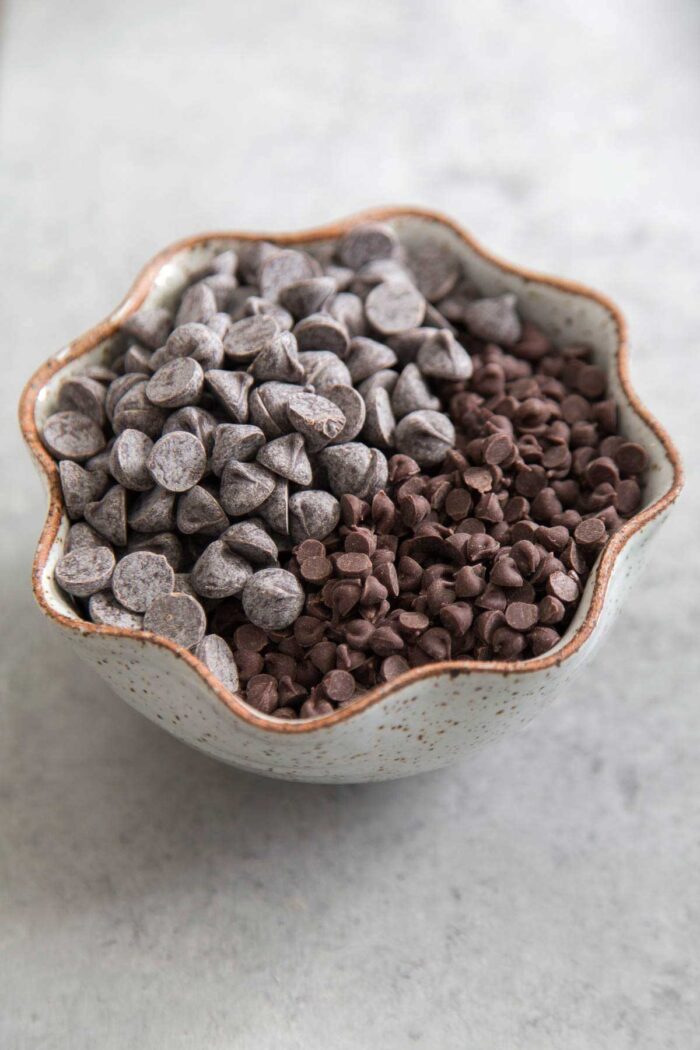 mixture of standard chocolate chips and mini chocolate chips in bowl. 