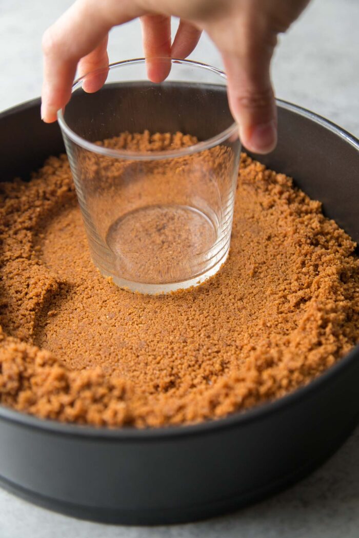 ground biscoff cookies mixed with melted butter pressed into springform pan.